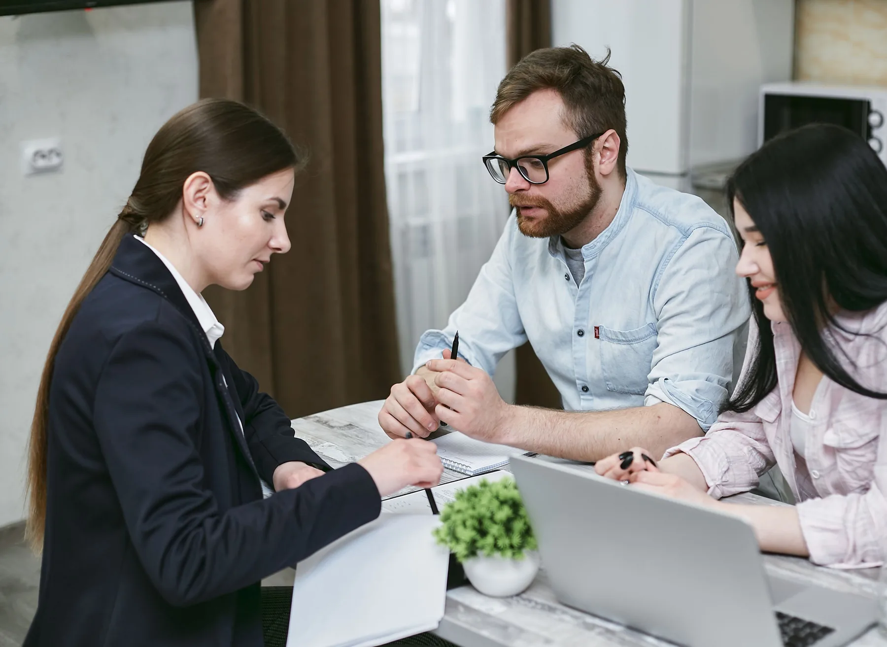 Professional advisory meeting with documents and laptop