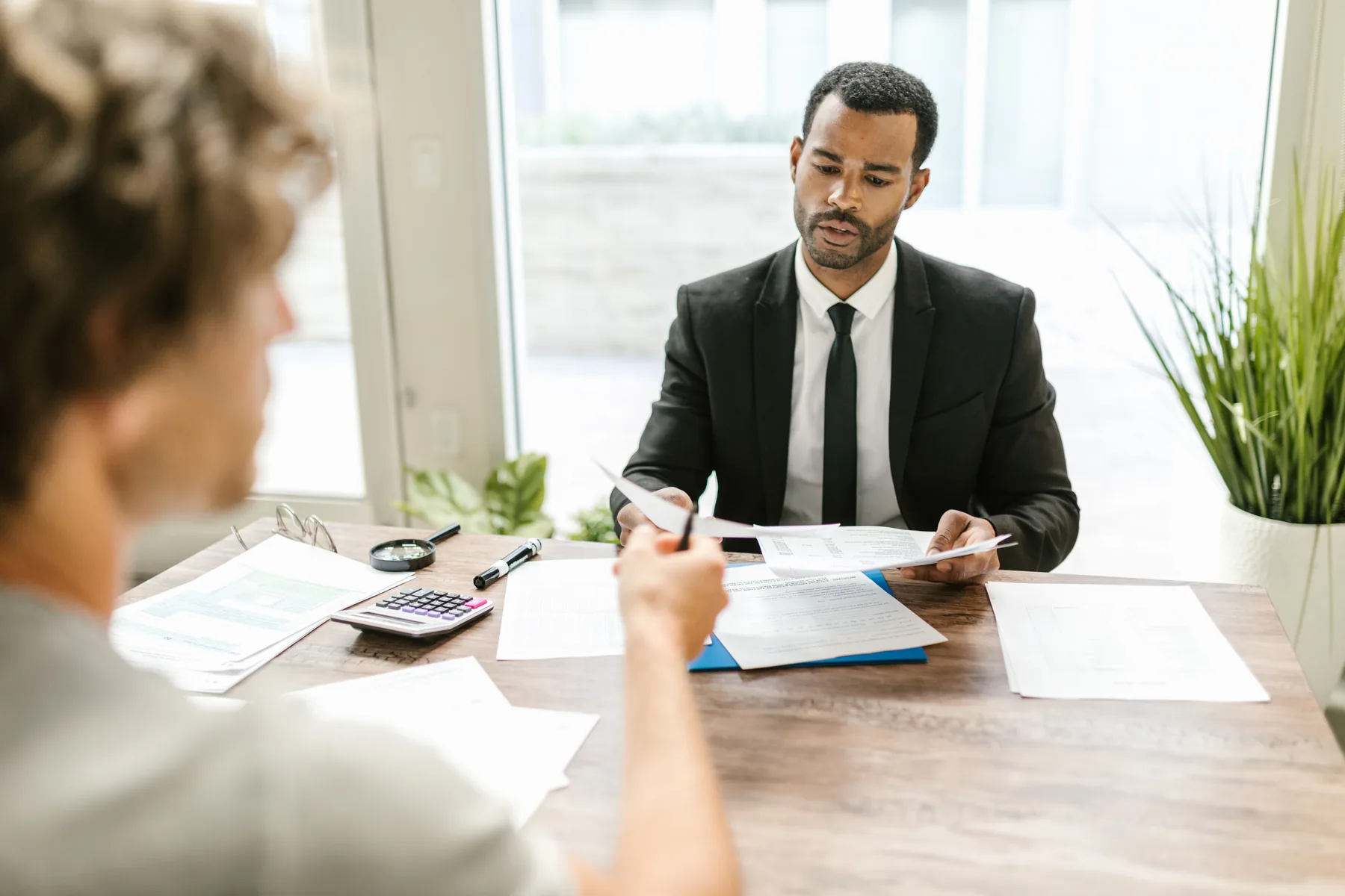 Professional reviewing documents with a client
