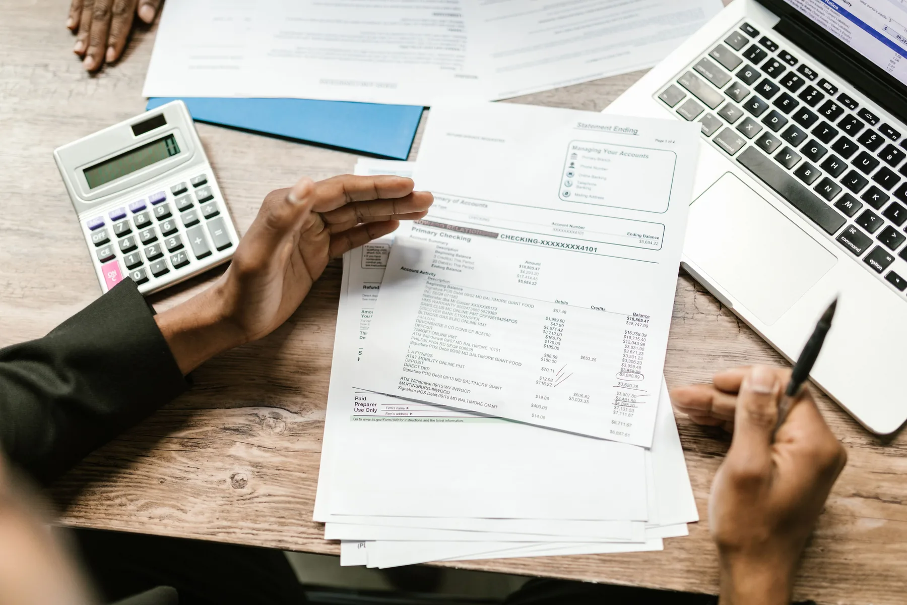 Financial documents and calculator being reviewed