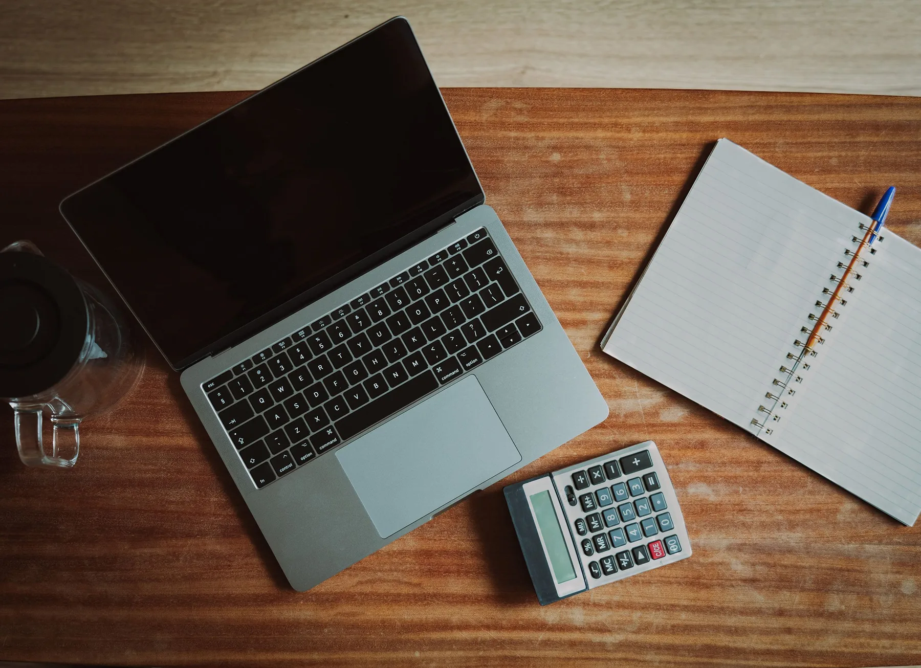 Laptop, calculator and notebook for account maintenance
