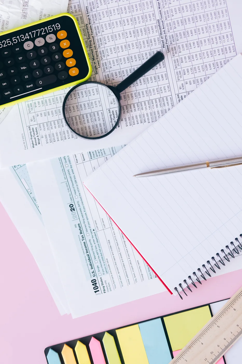 Tax documents, calculator and notebook